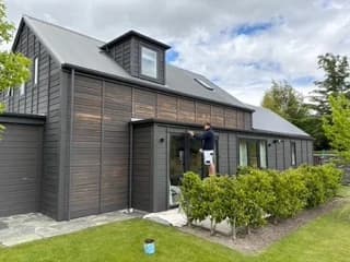 Painter working on the exterior of a Queenstown Lakes home